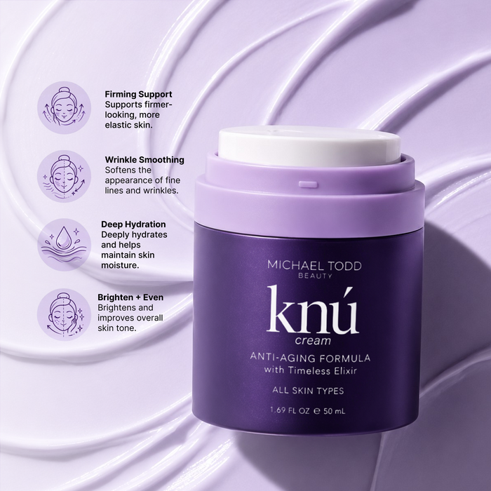 Open jar of Michael Todd Beauty knú cream resting on a swirl of light purple cream texture.